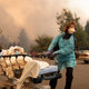Patients are quickly evacuated from the Feather River Hospital as it burns down during the Camp fire in Paradise, California on Nov. 8, 2018.